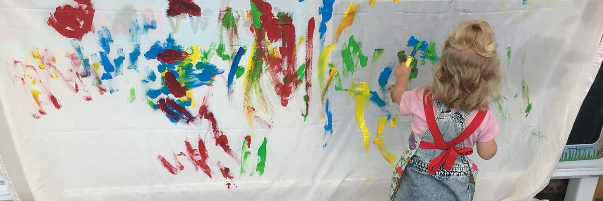 Children painting at Caego Day Nursery in Wrexham