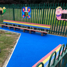 Outdoor play area with coloured benches