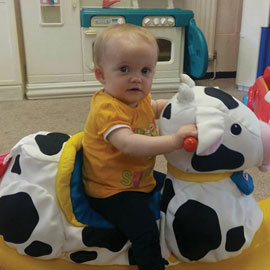 Nursery child playing with toys