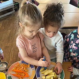 Children playing with moneyboxes in nursery
